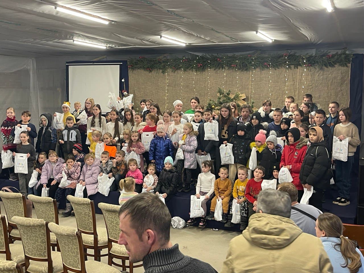 Children holding gift bags at a Christmas event at New Life Church