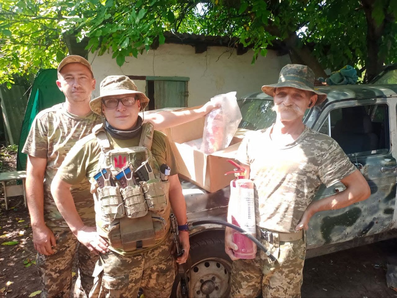 People with donated supplies beside a vehicle